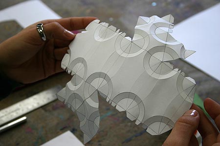 A complex pattern has been cut out, and the edges have been creased throughout, prior to gluing. Iteration #6, by Anna Sargent, Spring 2008. anna_sargent_in_progress