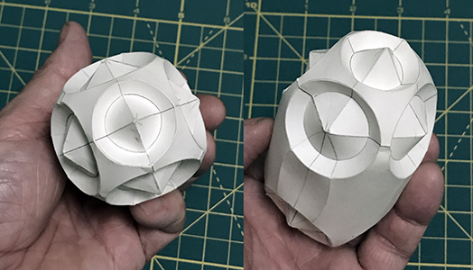 The assembled form, derived from a perfect cube, and evolved over five more transitions. At one point, the original cube was elongated, the ends were stellated, scallops were introduced, the corners were stepped, and some edges were curved. anna_sargent_assembled