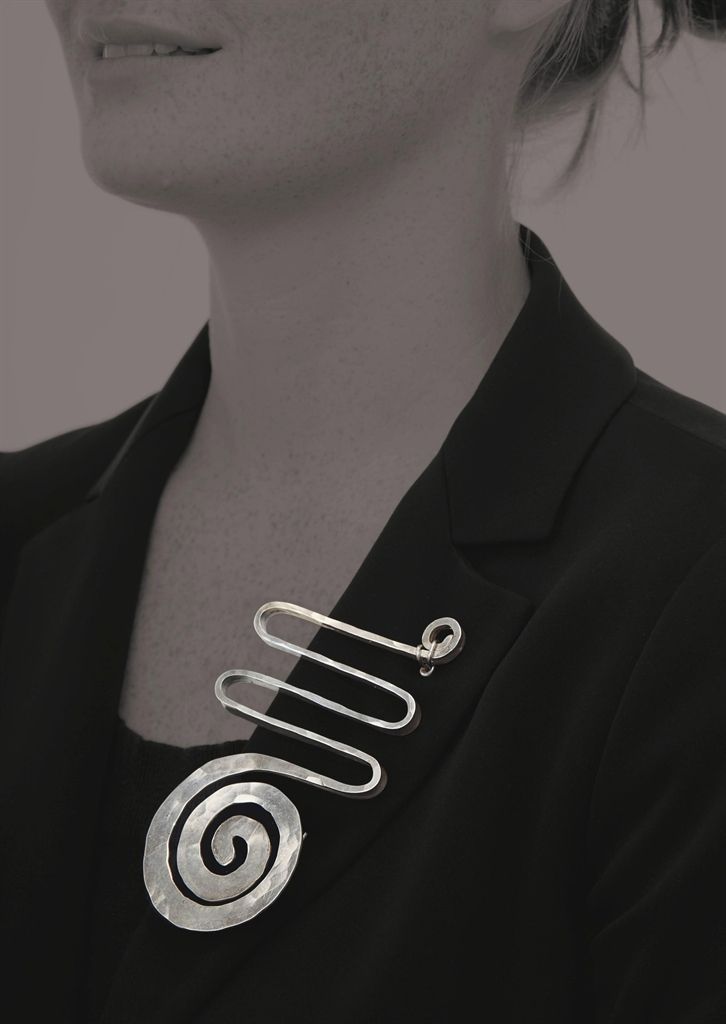 Brooch with spiral and meander on model. calder-brooch-2